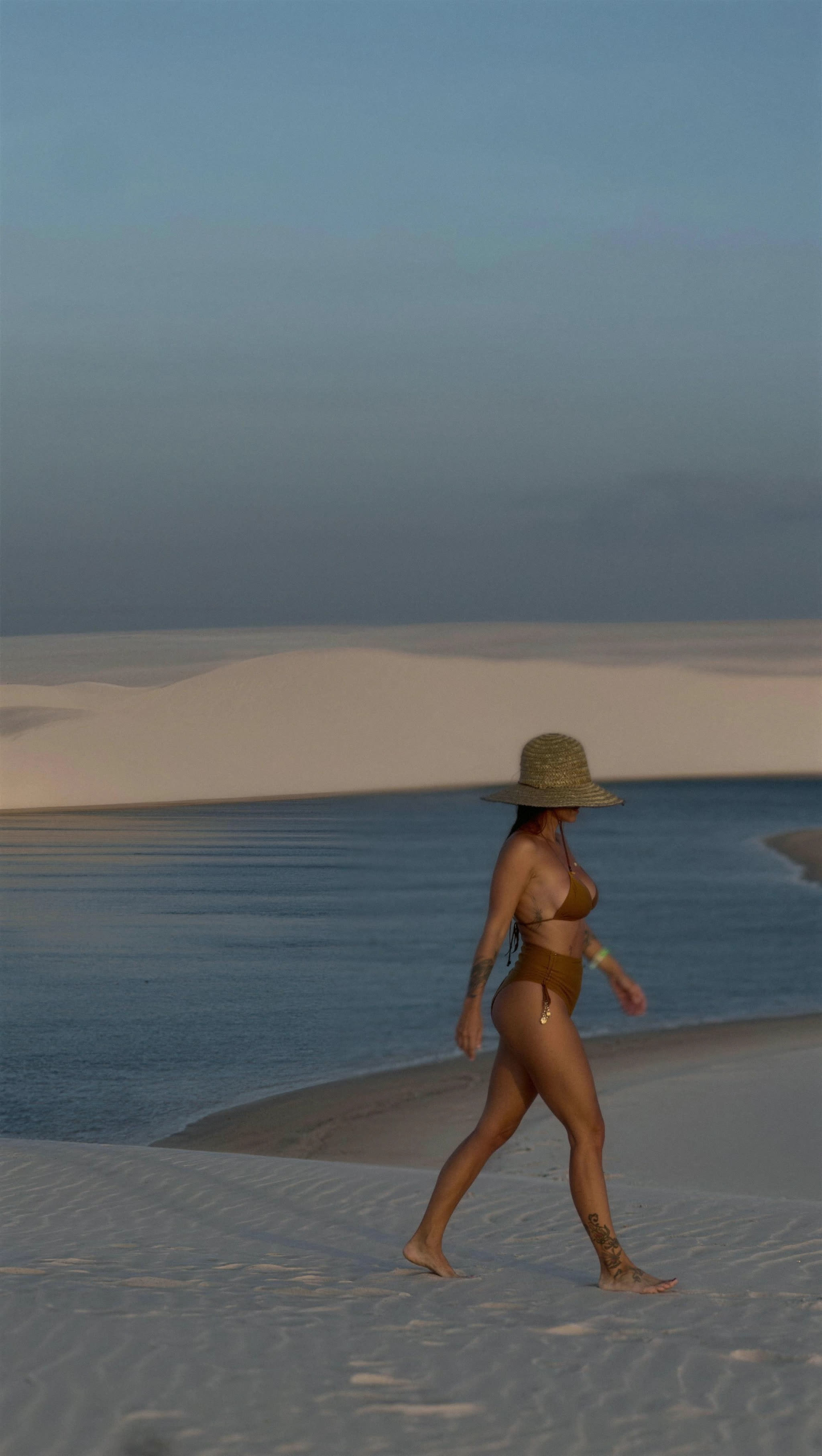 Turquoise lagoon between white dunes