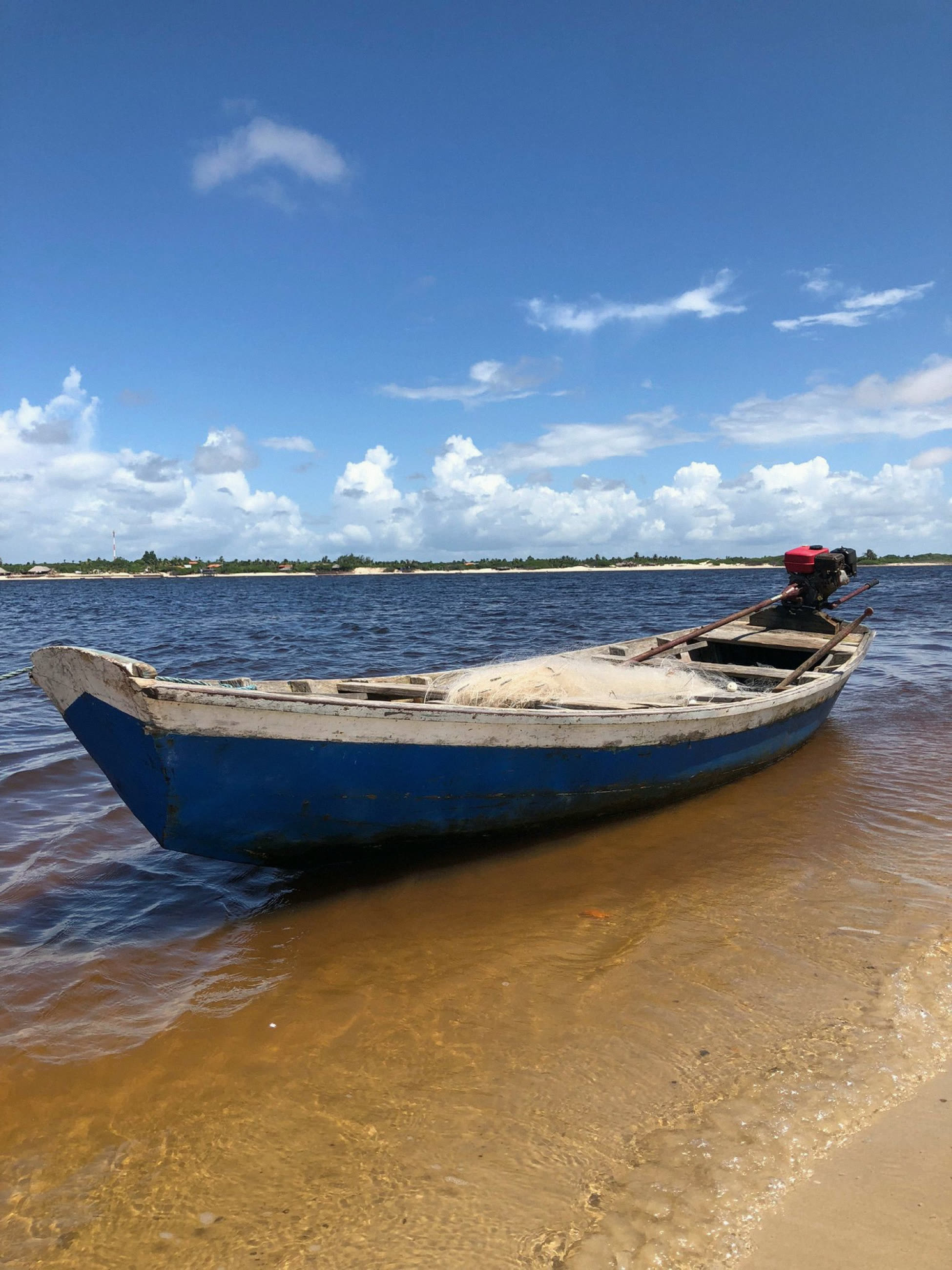 A wooden canoe at the river's edge